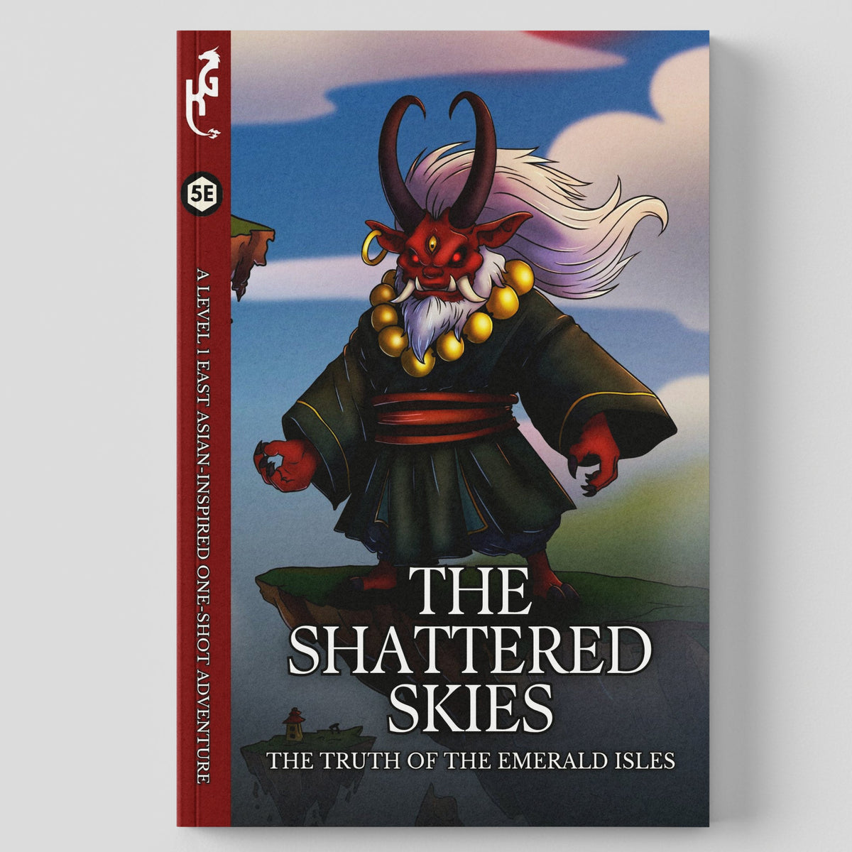 A single book or comic-style cover shown upright on a light gray background. The cover features illustrated fantasy artwork of a horned red creature in dark robes, with the title text 'THE SHATTERED SKIES' and smaller text 'THE TRUTH OF THE EMERALD ISLES.